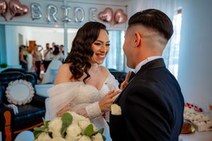 A candid wedding photo showing laughter and happiness with elegant decor in the background.