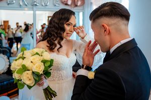 Wedding celebration scene with rose gold 'BRIDE' balloons and elegant white decor in an indoor setting.
