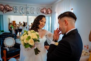 Wedding celebration with white and rose gold decorations featuring elegant floral arrangements.