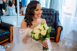 Beautiful bridal moment featuring a classic white rose bouquet and delicate veil.