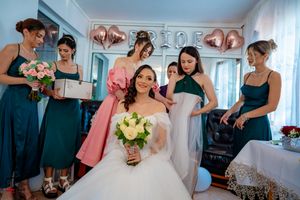 Emotional wedding preparation scene with attendants in teal and coral dresses.