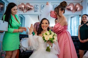 Wedding celebration scene with attendants in green, pink and teal dresses.