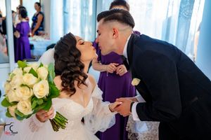 A tender moment shared between a couple in formal attire at a wedding celebration.