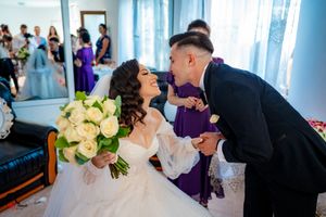 An intimate wedding moment captured with light blue decor in the background.