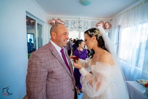 Emotional wedding preparations in a light-filled room with balloon decorations and white decor.