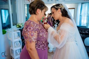 Wedding celebration moment captured in a room with heart balloons and white decorative elements.
