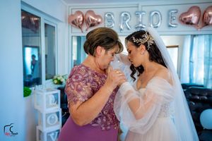 Intimate wedding scene with decorative balloons and white curtains creating a romantic atmosphere.