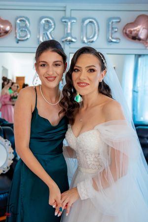 Candid moments during wedding preparations with bridesmaids in teal dresses and bride in white gown.
