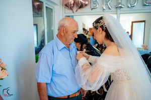 Intimate family moments during wedding preparations in a light-filled room.