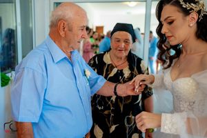 Touching pre-ceremony moments with family members in a decorated bridal suite.