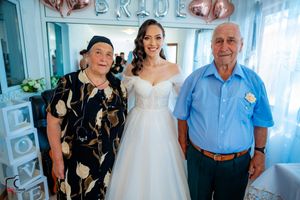 Candid wedding preparation moments with family in a decorated room.