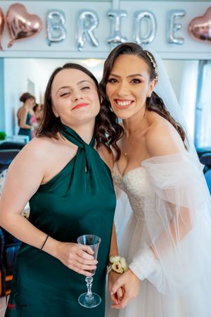 Wedding celebration with guests in emerald green and white attire.