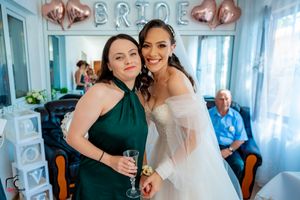 Wedding celebration scene with rose gold balloons and light blue interior.
