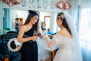 Wedding party gathering with emerald green and white color scheme.