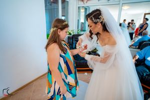 Intimate wedding moments captured in a bright dressing room with mirrors.