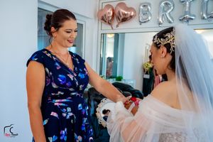 Wedding party members in floral and navy dresses share pre-ceremony moments.