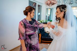 Wedding preparation moments with guests in colorful dresses and bride in white.