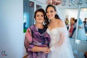 Emotional pre-wedding moments shared in bridal suite with purple and white attire.