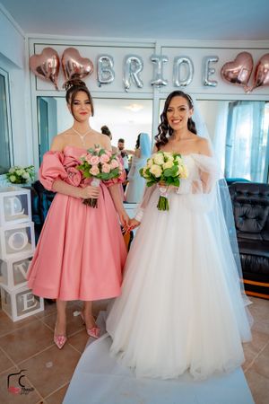 Wedding celebration scene with pink heart balloons and 'BRIDE' lettering decoration.
