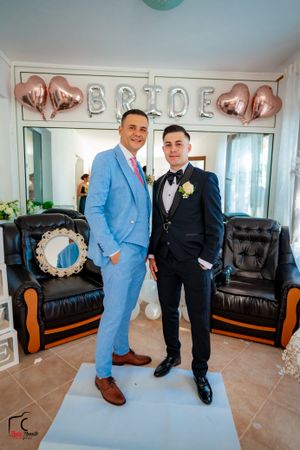 Formal event photos showing attendees in light blue and black suits with balloon decorations.
