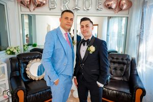 Wedding party photos featuring light blue and black suits against balloon decorated backdrop.