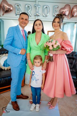 Wedding group photos with pink and blue attire under silver balloon decorations.