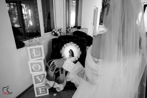 Artistic black and white shot of bridal accessories and decor in preparation room.