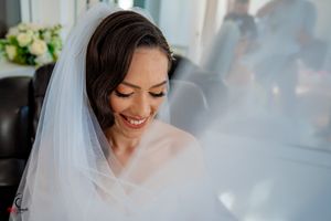 A bridal portrait series showing joyful expressions and delicate white veil details in soft lighting.
