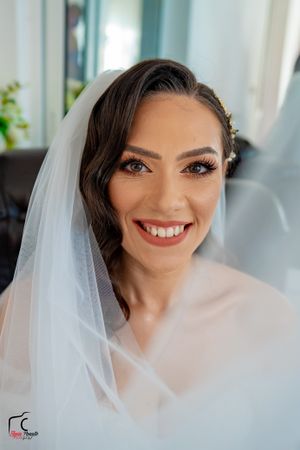 Close-up shots of a bride's radiant smile and flawless makeup on her wedding day.
