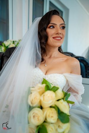Wedding portrait series featuring cream roses and delicate bridal details.