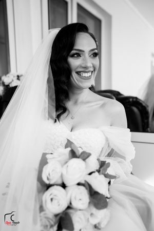 Black and white series of joyful bridal portraits with white rose bouquet.