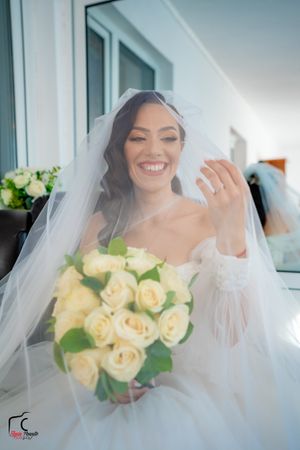 Light and airy bridal portraits with cream roses and ethereal veil effects.