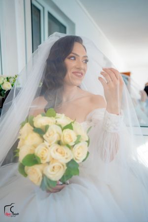 Ethereal wedding photography series featuring soft lighting and cream rose bouquet details.