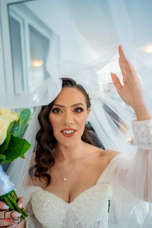 A close-up view of a bride wearing a lace wedding dress with a delicate veil.