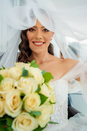 Wedding photography featuring soft veil details and cream colored rose bouquet.