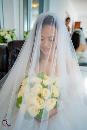 Dreamy bridal photos through sheer veil with pale yellow roses.