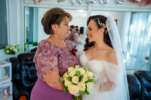 A touching wedding scene with two people sharing an emotional moment and yellow roses.