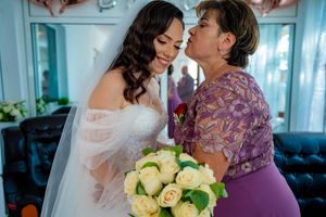 A joyful wedding moment captured with a beautiful bouquet of pale yellow roses.