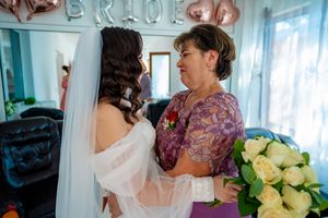 An intimate wedding scene with soft lighting and a beautiful bouquet of cream roses.