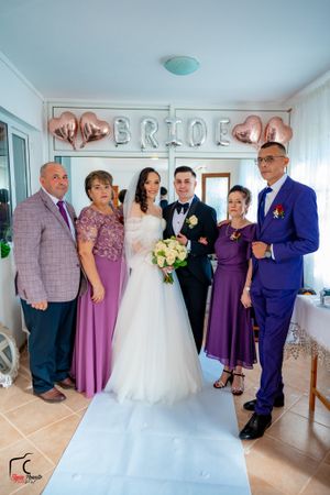 Wedding celebration with guests in coordinated purple and blue formal wear.