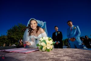 Marriage certificate signing captured with dramatic low angle composition.