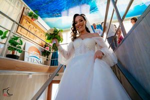 Wedding venue decorated with white fabric and blue accent lighting creating a romantic atmosphere.
