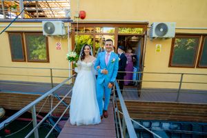 Wedding venue exterior with yellow walls and modern air conditioning units mounted.