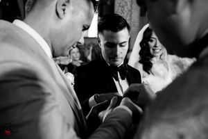 Elegant wedding ceremony taking place in a beautifully decorated indoor venue with warm lighting.