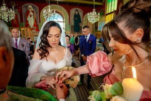 Wedding celebration with candlelight and decorative elements in an ornate indoor setting.