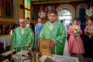 Orthodox wedding ceremony in progress within a lavishly decorated church interior.