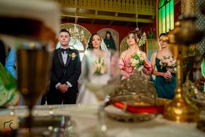 Elegant wedding scene captured through decorative elements in a historic venue with ornate ceiling details.