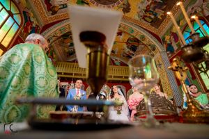 Creative wedding photo composition using architectural elements to frame the celebration scene.