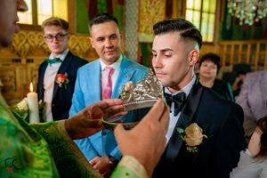 Guests gather in an ornately decorated venue during a formal wedding celebration.