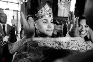 Wedding ceremony showing decorative green fabric and ornate crown details in an elegant church setting.
